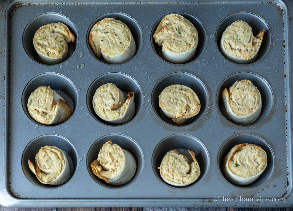 Baked chicken pinwheels in a muffin tray.