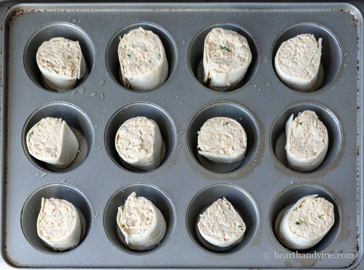 Chicken pinwheels in a muffin pan.