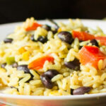 A close look at some rice and bean casserole on a plate.