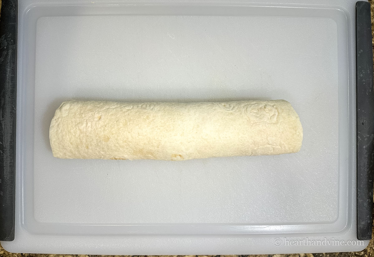 Chicken mixture rolled up in a tortilla.