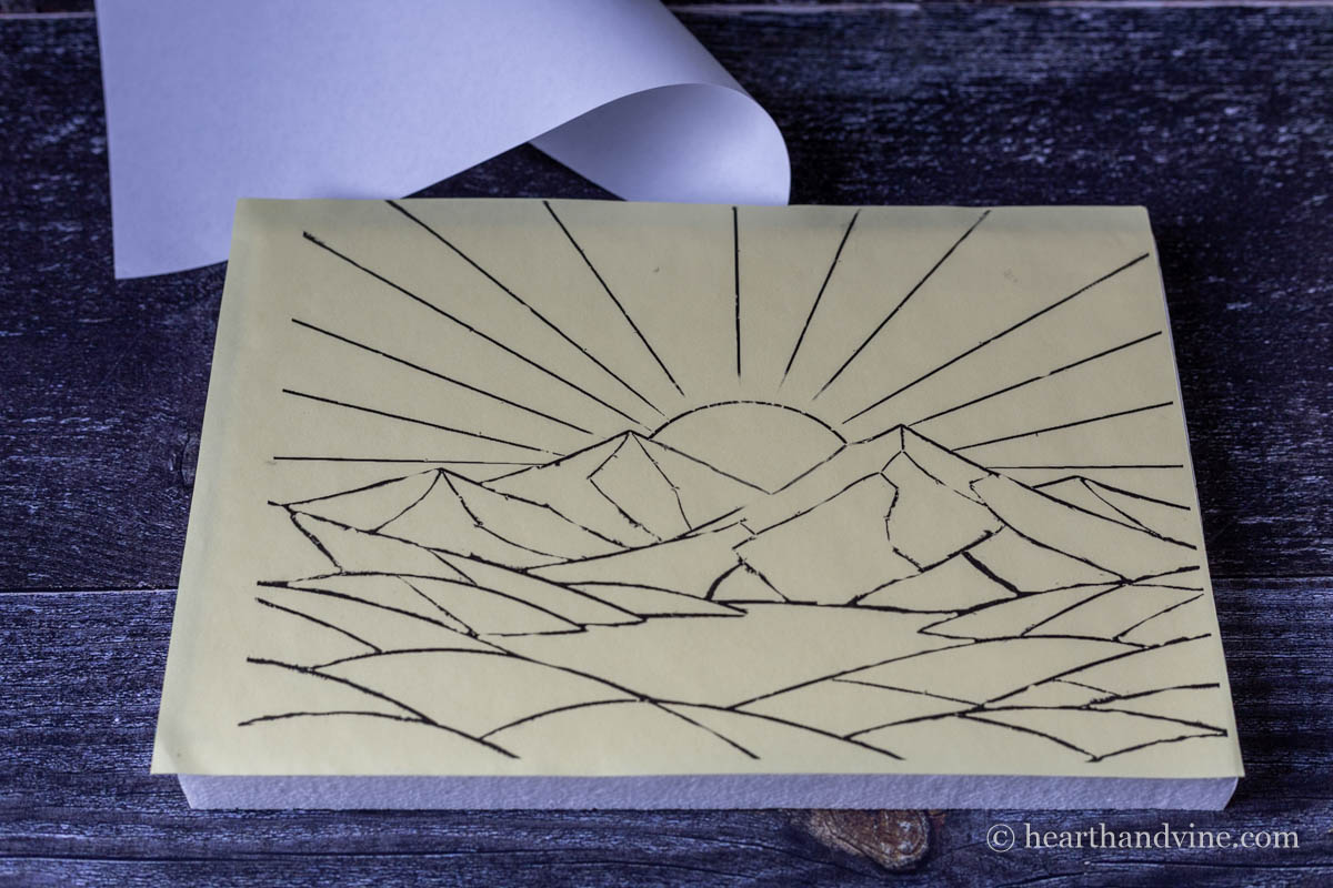 The adhesive paper with the template printed adhered to a foam block.