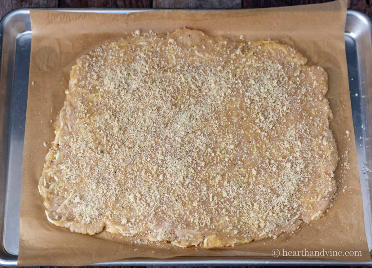 Panko breadcrumbs and parmesan cheese sprinkled over chicken crust.