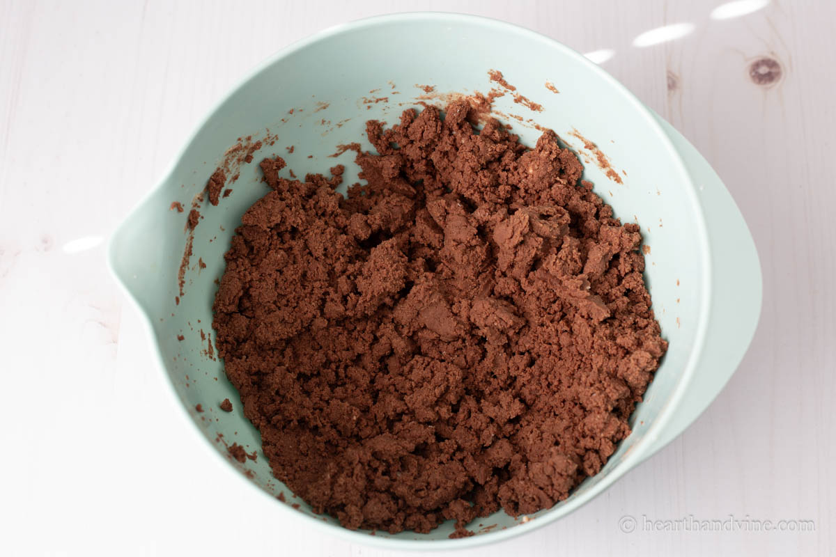 Dry and wet ingredients combined together in a mixing bowl.