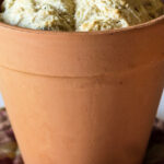 A large clay pot with herbal beer bread baked inside.