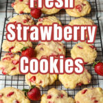 A dozen strawberry cookies on a wire rack.