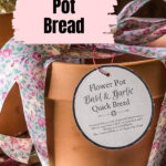 A terracotta pot with a ribbon and tag for baking bread.