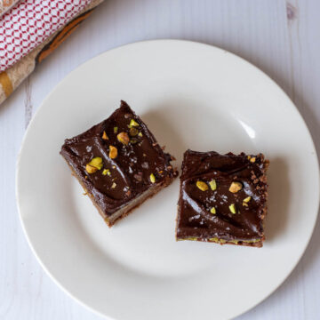 Two pistachio chocolate bars on a plate.
