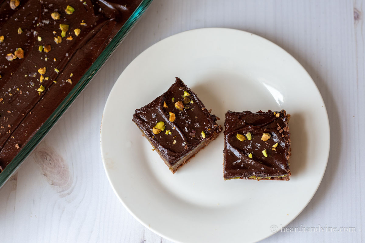 Aerial view of two pistachio chocolate bars on a plate.