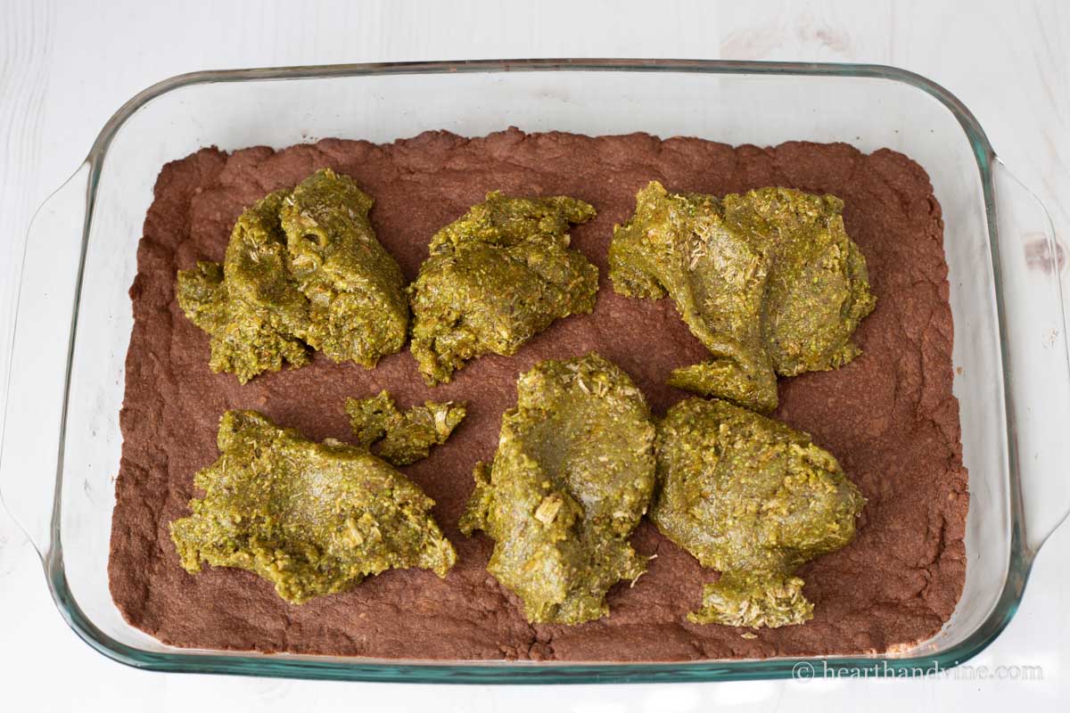 Drops of the pistachio mixture on top of the chocolate shortbread crust.