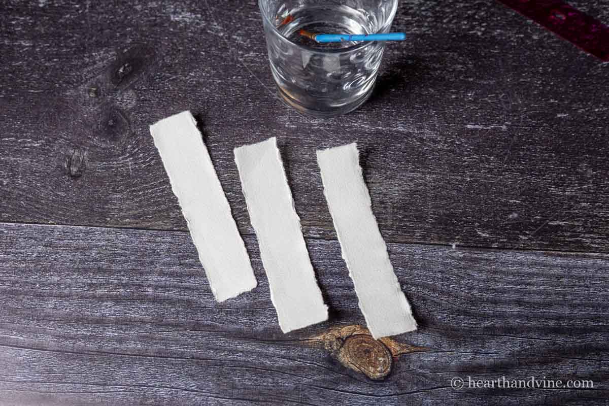Torn edges of heavy white paper.