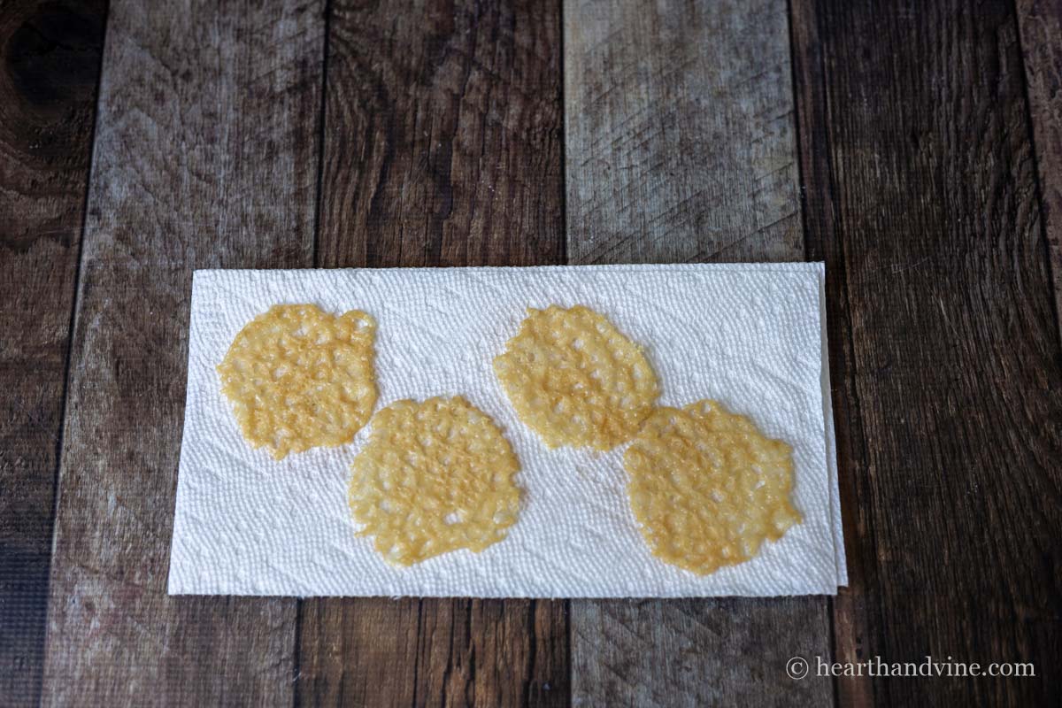 Parmesan crisps on paper toweling.