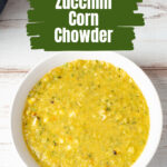 A white serving bowl of zucchini and corn chowder.