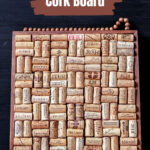 A wine cork board on a table leaning on a blackboard.