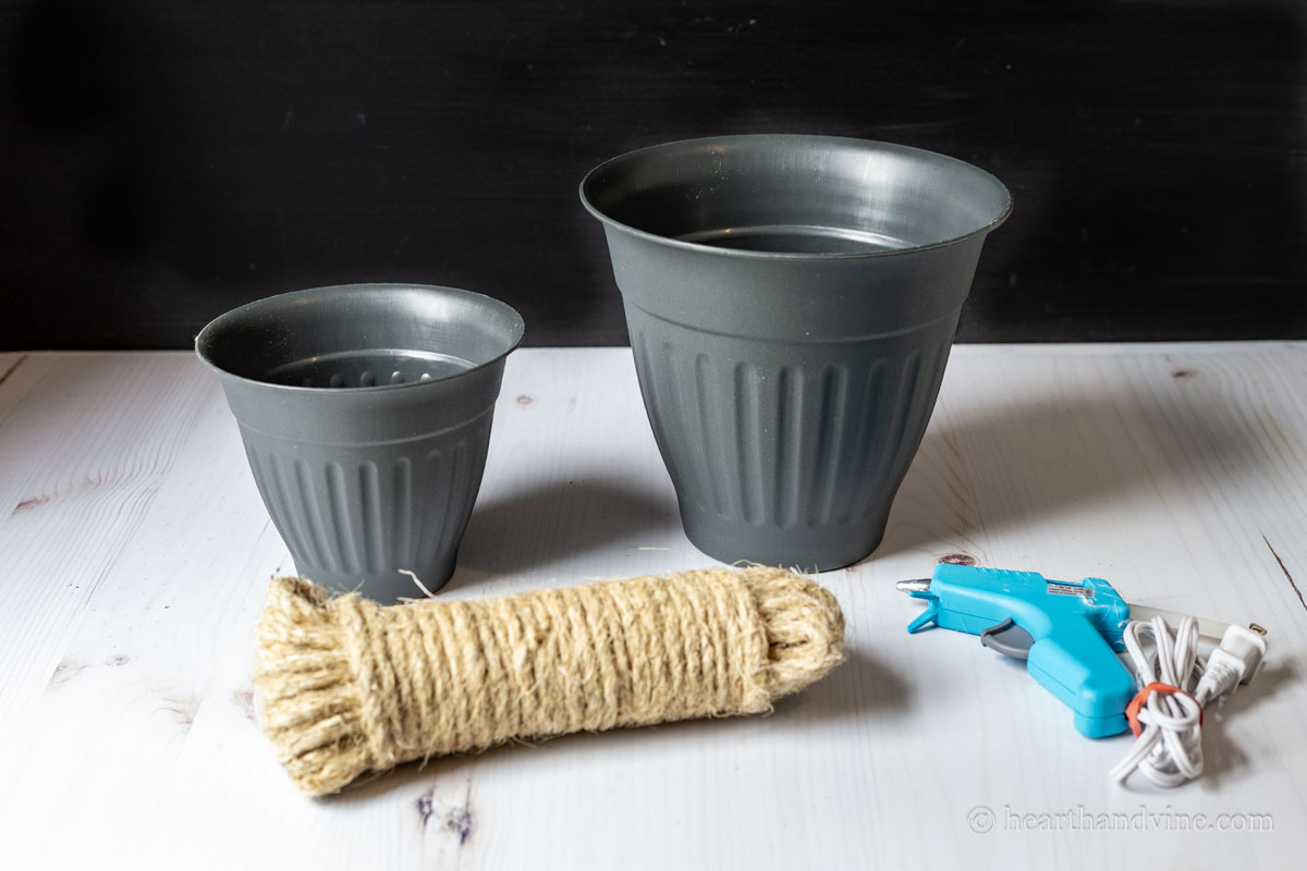 Supplies for making bee skeps including plastic pots, sisal rope and a hot glue gun.