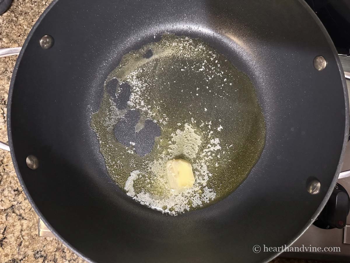 A large skillet with butter and olive oil.