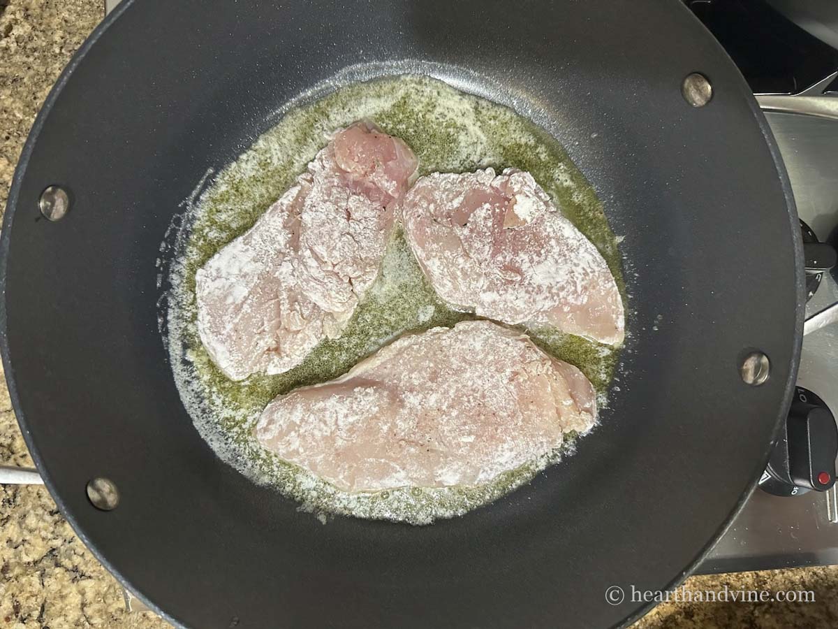 Chicken breast browning in skillet.