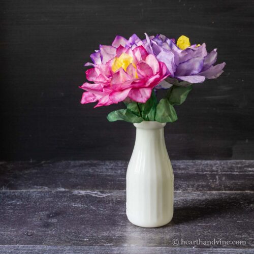 Coffee filter flowers in a white milk vase.