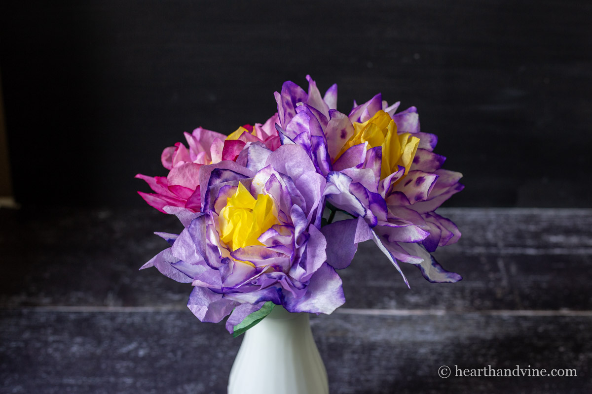 Three coffee filter flowers in a white milk vase.