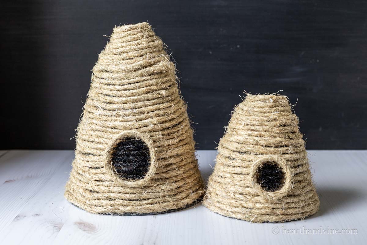 A large and small bee skep made with pots and sisal rope.