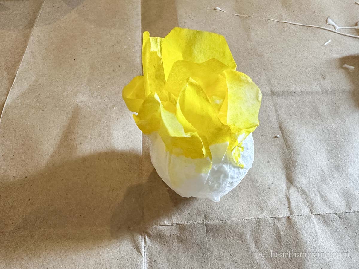 Yellow coffee filter flower glued to a styrofoam ball.