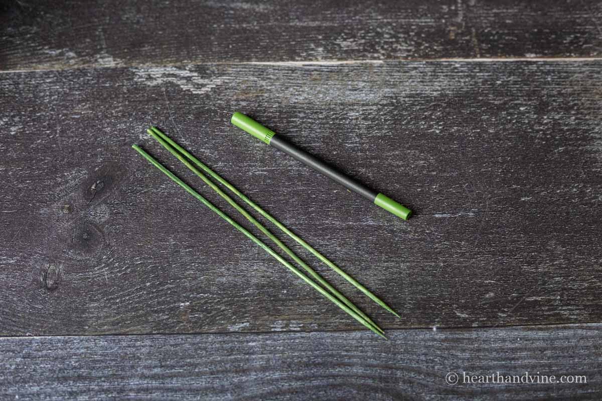 Wooden skewers colored green with a marker.