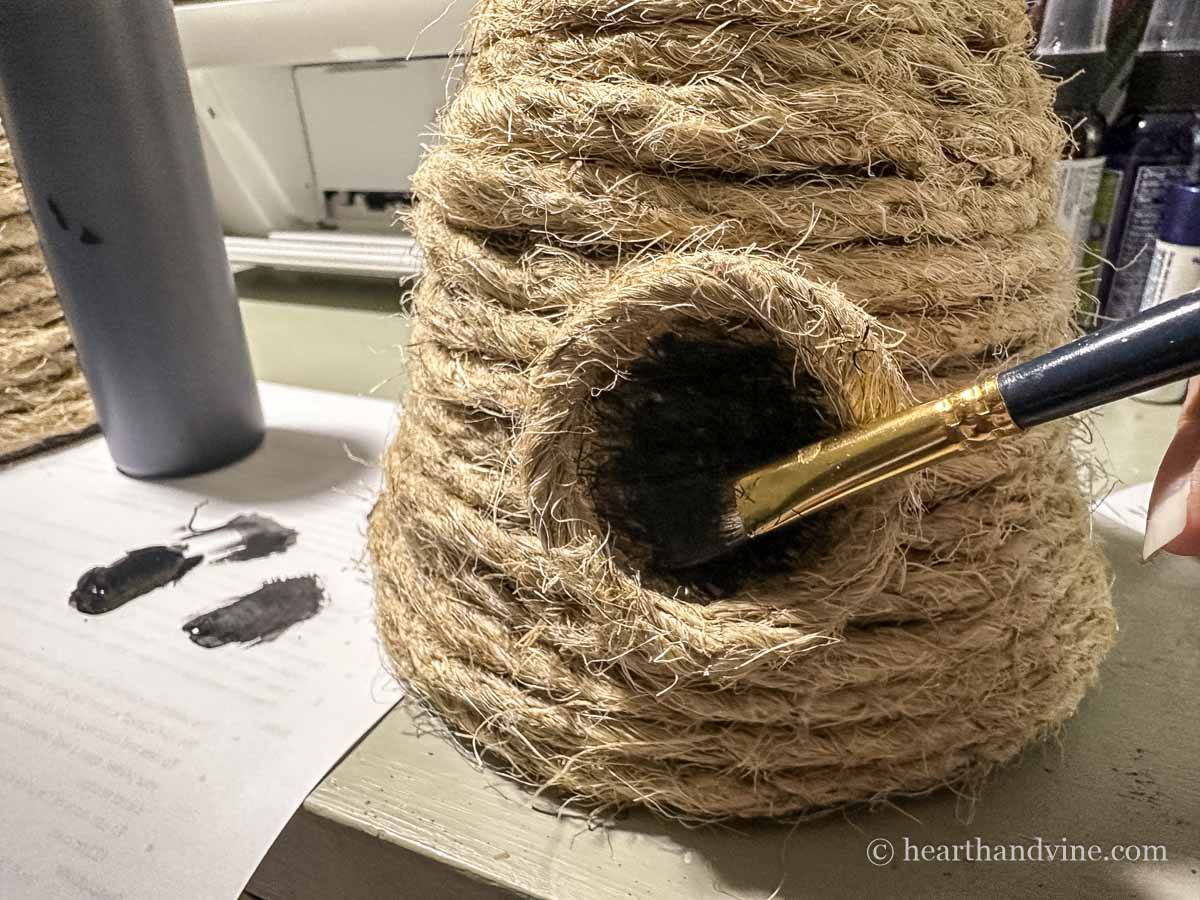 Handmade bee skep close look at painting the circle in front to look like an opening.
