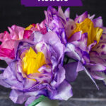 Pink and purple coffee filter flowers in a white vase.