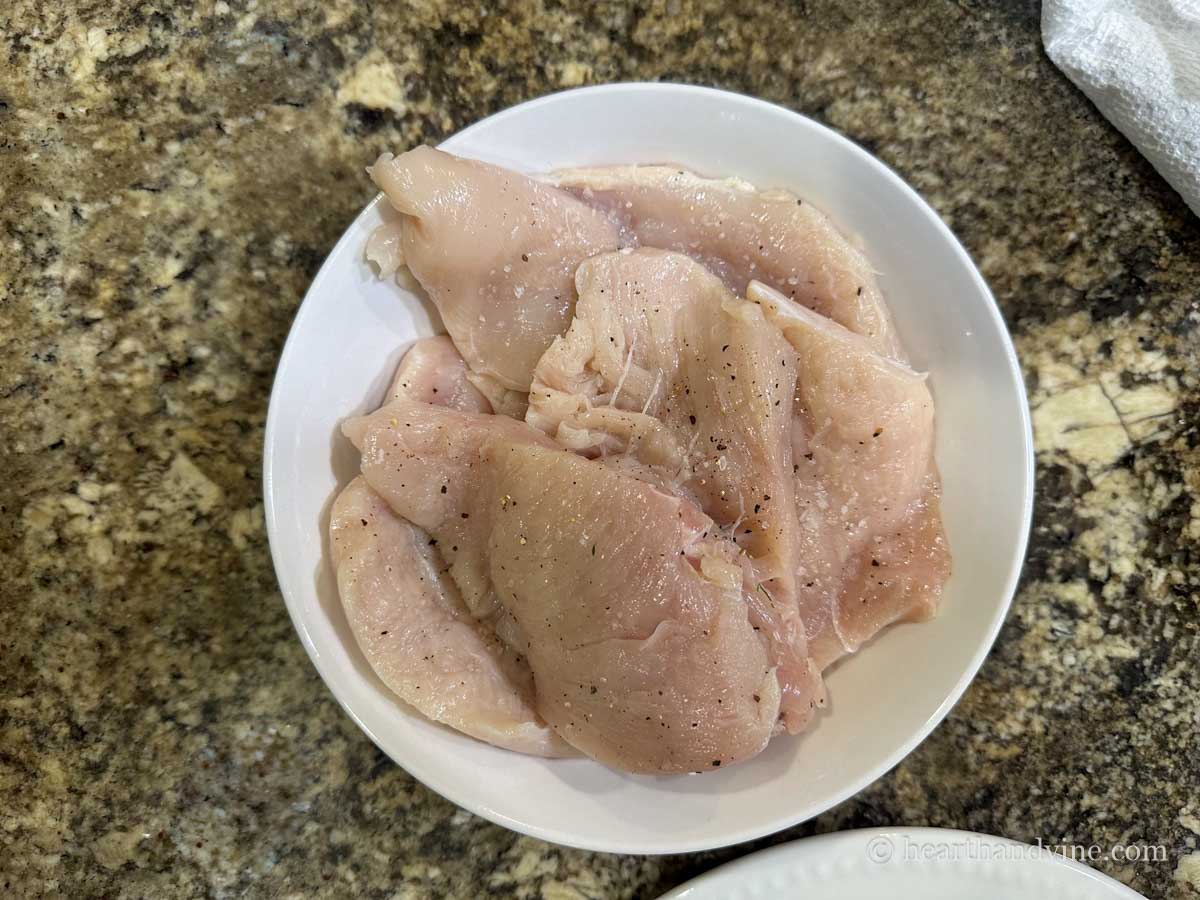 Thin sliced chicken breast seasoned with salt and black pepper.