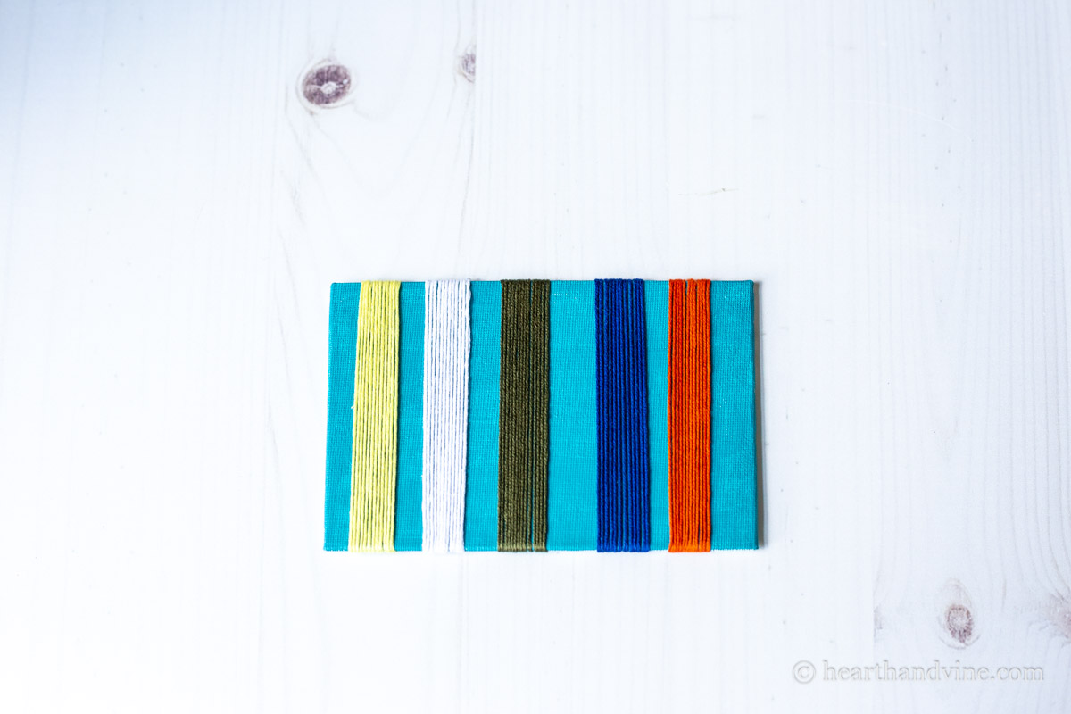 Five rows of different colored embroidery threads in 1/2 inch chunks.