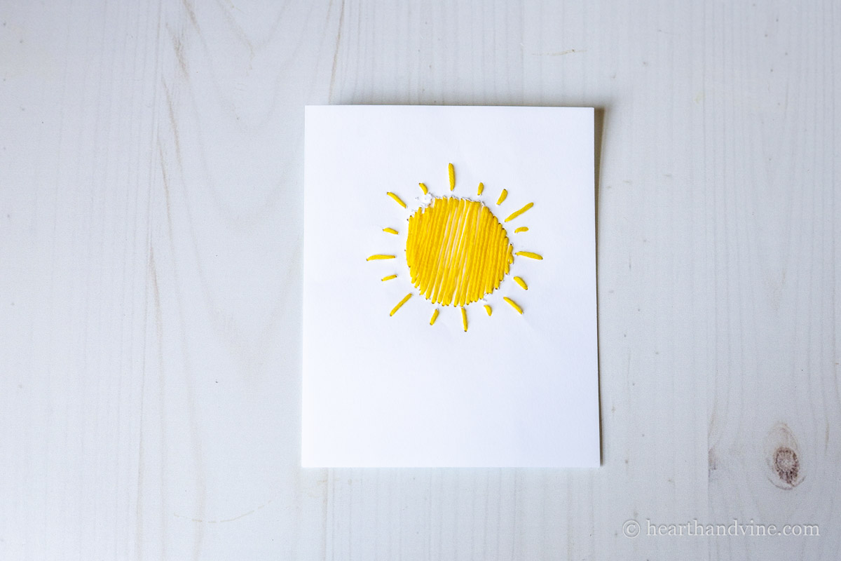 Sun design embroidered card.