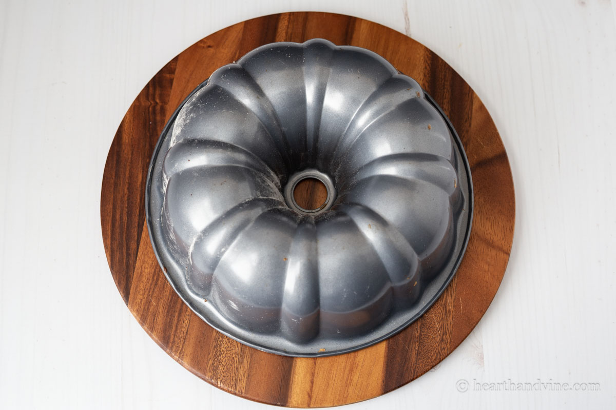 Bundt pan flipped onto a wooden platter.
