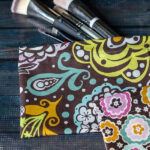 Colorful cotton fabric snap bags with makeup brushes sticking out.