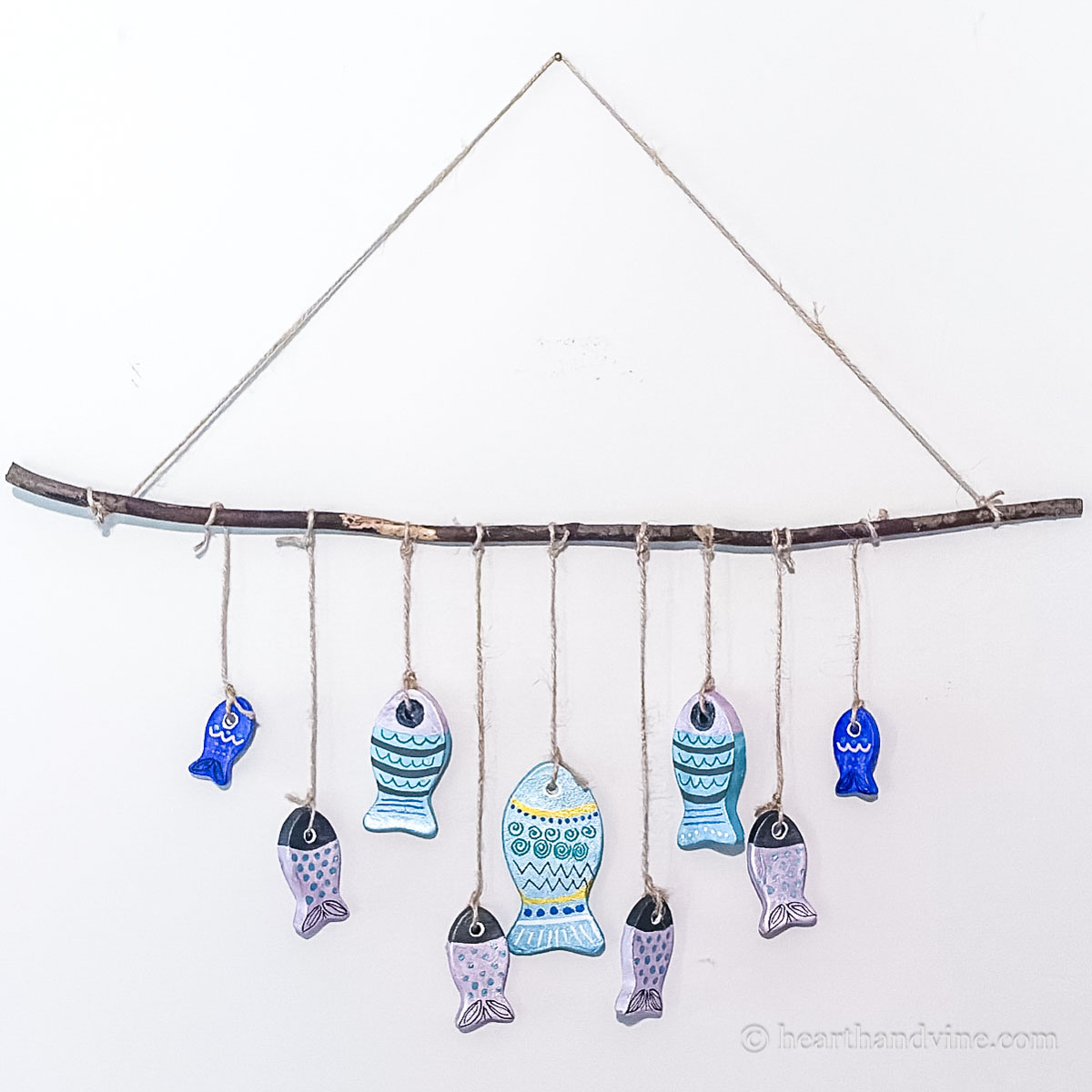 Clay fish craft wall hanging on wall.