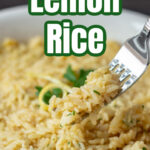 A fork lifting a bite of lemon rice from a serving bowl.