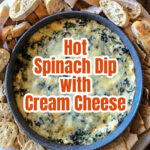 An aerial view of a creamy spinach dip with crackers and bread rounds on the side.