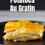 Slice of potatoes au gratin on a black plate.