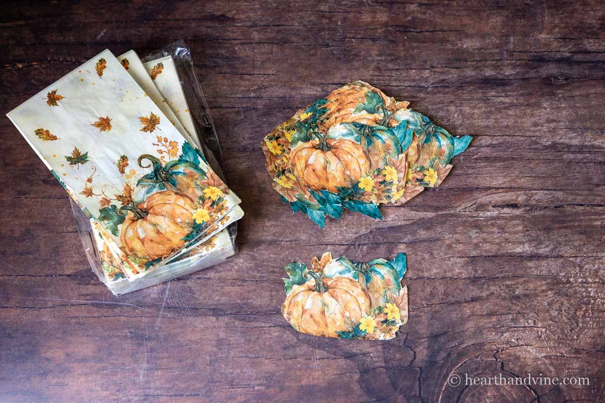 Pumpkin napkins next to some of the same cut out into shapes.