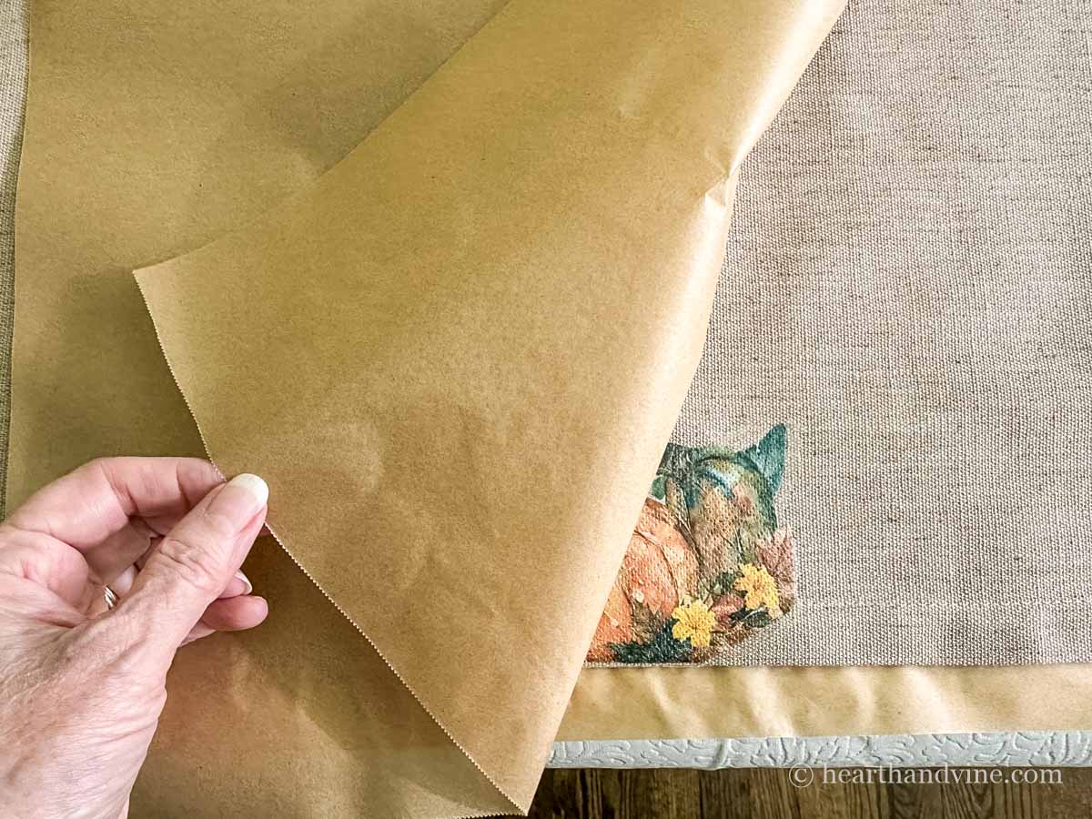 Corner of parchment paper lifted to check the napkin decal.