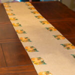 Pumpkin themed napkins on a table runner.