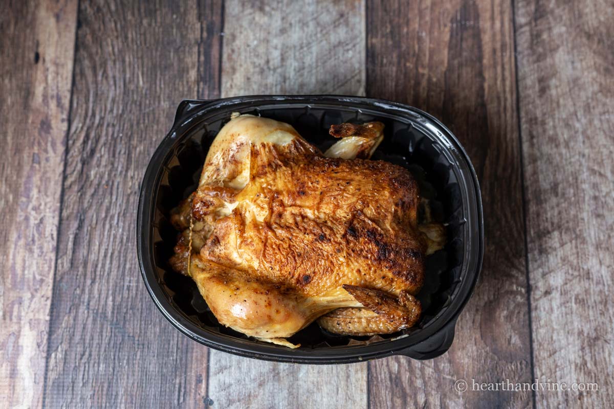 Cooked rotisserie chicken in its container.
