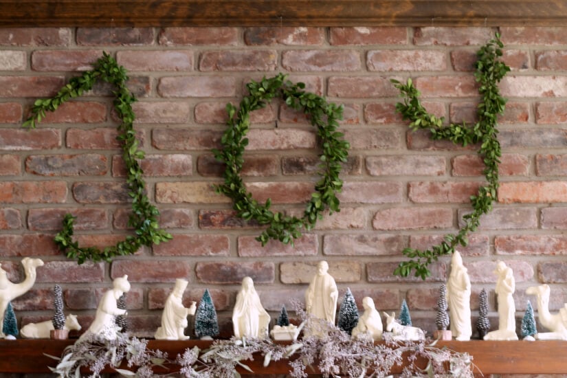 Wire hanger boxwood letters tutorial hung above the mantel