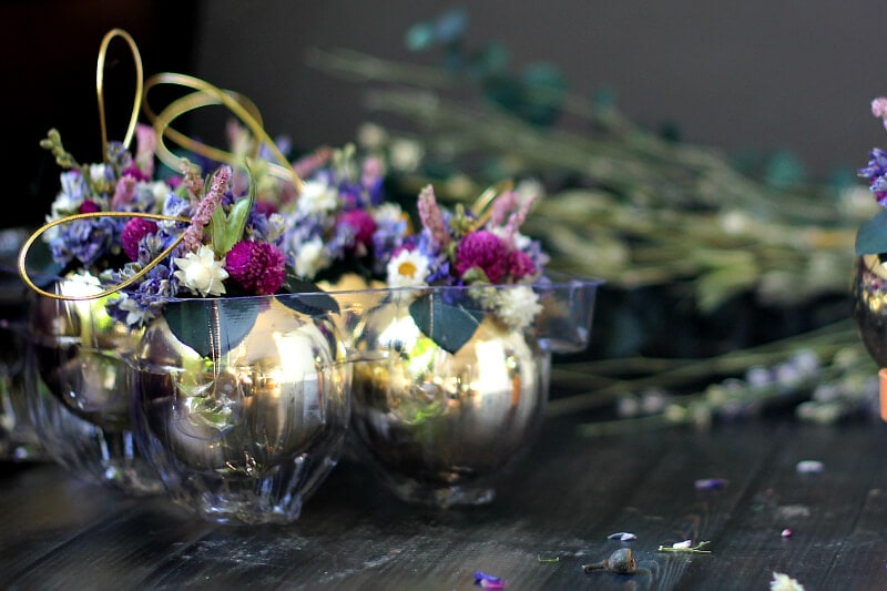 Dried flower ornaments in a plastic storage container.