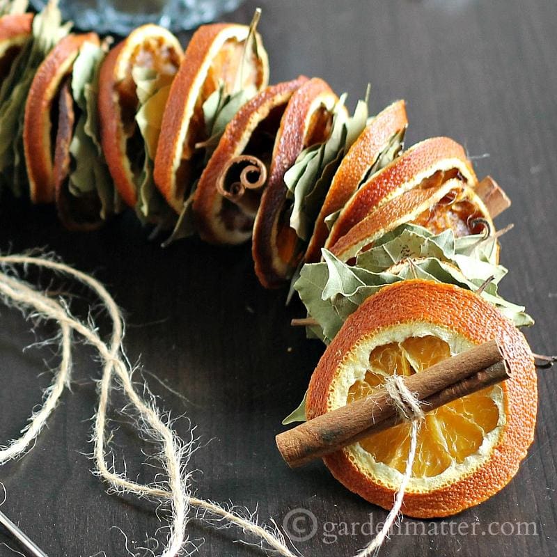 This dried orange garland project made with bay leaves, and cinnamon sticks is easy to create, and make a beautiful statement in your fall or winter decor.